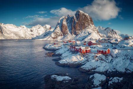 Hamnoy fishing village on Lofoten Islands, Norway with red rorbu houses in winter. Concept of Travel and holiday on nature, tourist and fishing leisure. Iconic location for landscape photographers